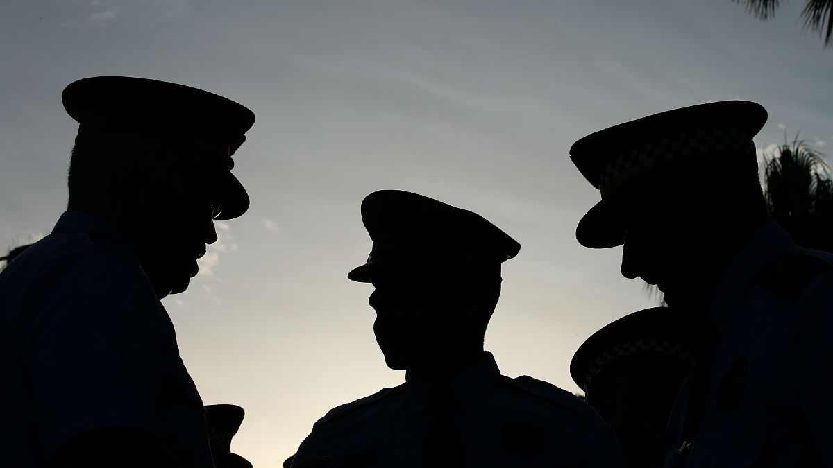 Mossos d'Esquadra officers speak before a rally against the Barcelona and C