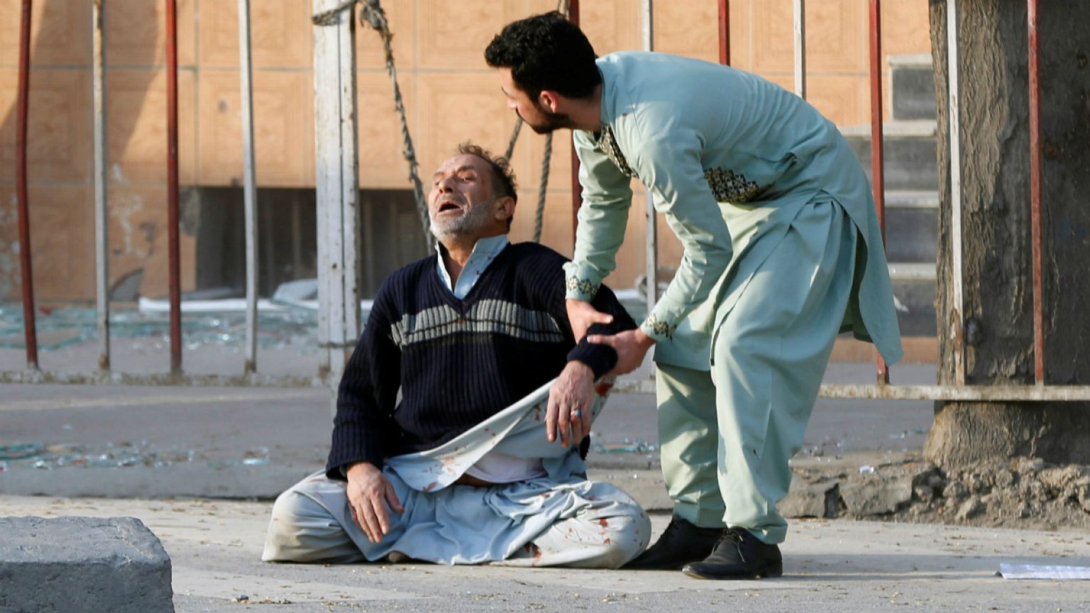 Injured man receives medical assistance after a blast in Kabul