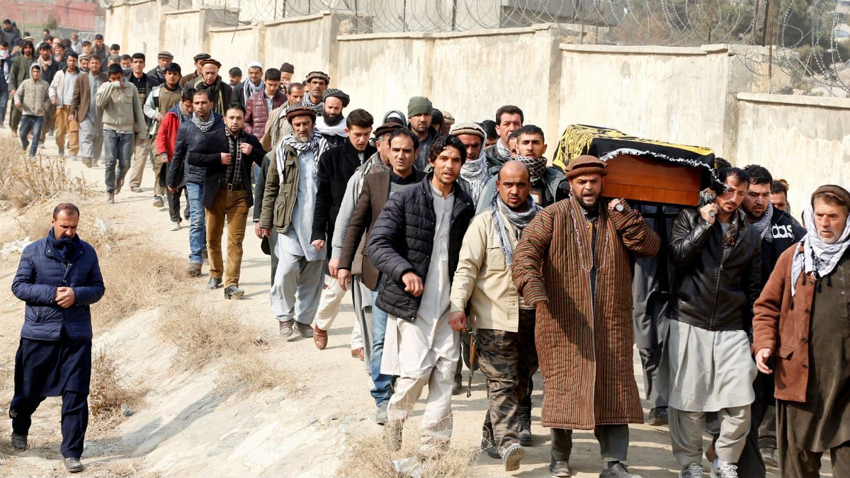 Afghan men carry the coffin of one of the victims 