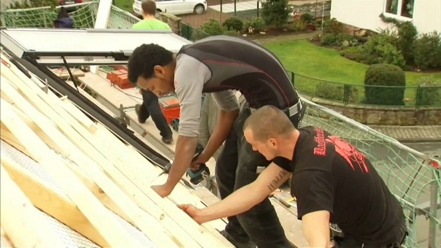 A refugee from Eritrea is trained in roofing in Germany