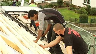 A refugee from Eritrea is trained in roofing in Germany