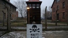 Kétnyelvű felirat az auschwitzi haláltábor kerítésén Oświęcimben.