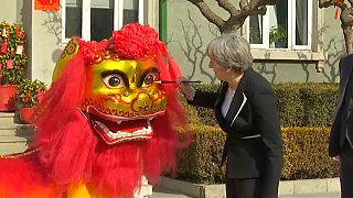 British Prime Minister Theresa May enjoys a lion dance