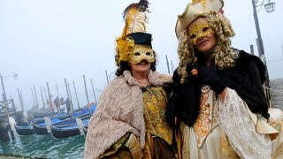 Masked revellers pose during the Carnival in Venice