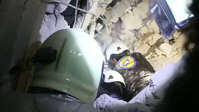 White Helmets rescue a baby from the rubble after airstrikes in Idlib