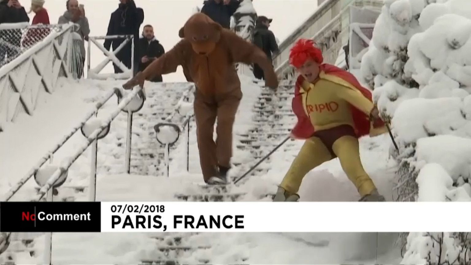 A super hero and his sidekick snow down the slopes of Sacre Coeur 