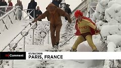 A super hero and his sidekick snow down the slopes of Sacre Coeur 