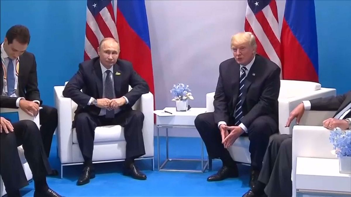 Vladimir Putin with Donald Trump at a summit in 2017