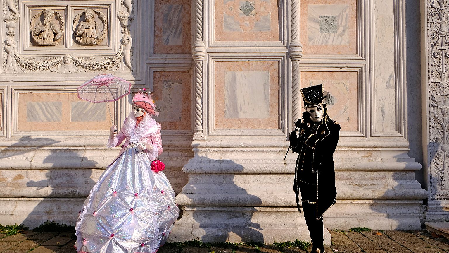 Masked revellers pose during the Venice Carnival in Venice, Italy
