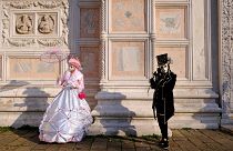 Masked revellers pose during the Venice Carnival in Venice, Italy