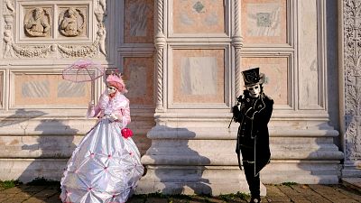 Masked revellers pose during the Venice Carnival in Venice, Italy