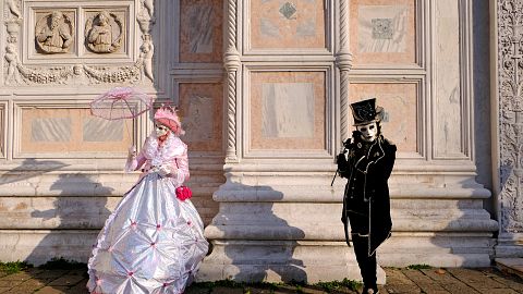 Masked revellers pose during the Venice Carnival in Venice, Italy
