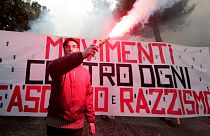 A banner reads "Movements against fascism and racism" in Macerata, Italy