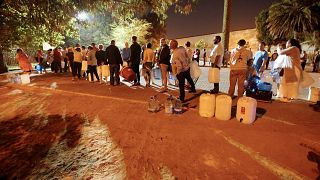 People queue to collect water from a spring in Cape Town