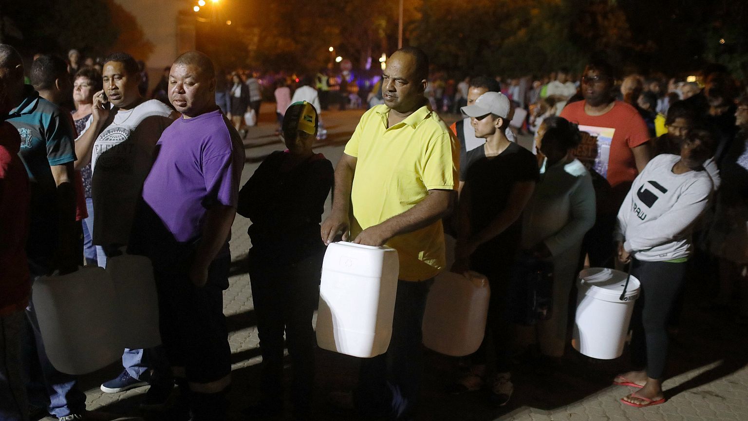 People queue to collect water in Cape Town, South Africa