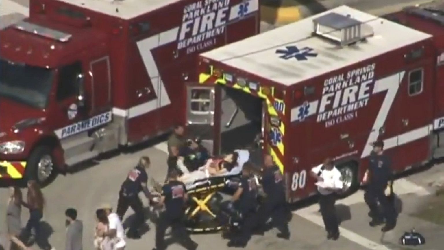 Rescue workers prepare to transport a victim on a stretcher, Florida