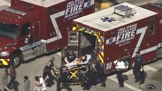 Rescue workers prepare to transport a victim on a stretcher, Florida