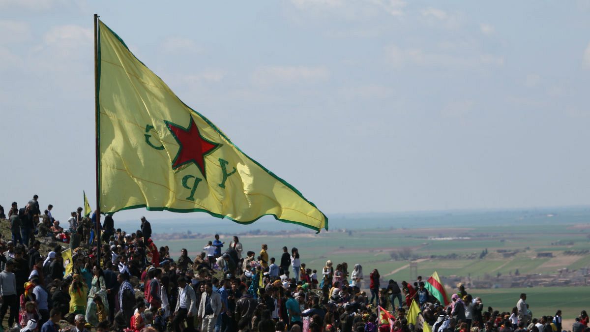 A Kurdish People's Protection Units (YPG) flag flutters