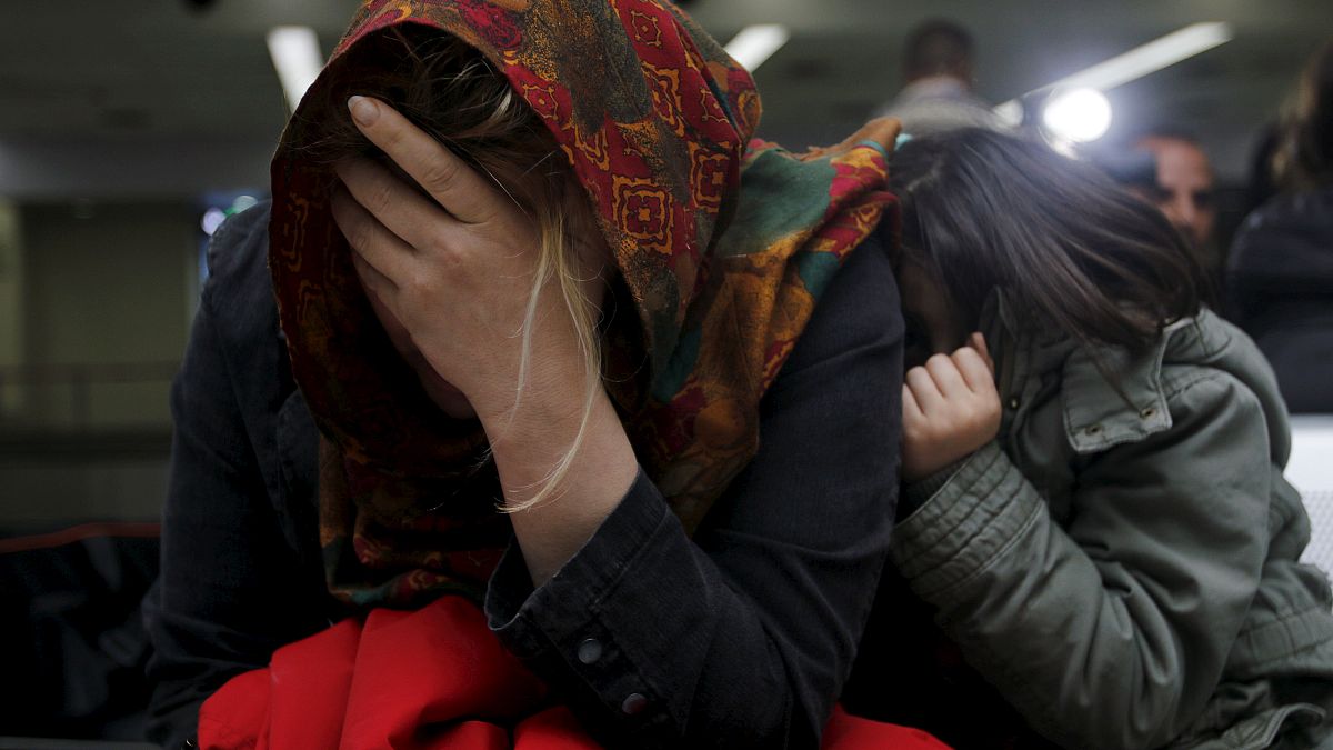 An Iraqi refugee woman returning from Finland reacts after arriving at Bagh