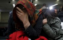 An Iraqi refugee woman returning from Finland reacts after arriving at Bagh