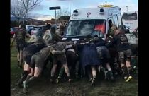 Rugby players form ‘scrum’ to free ambulance stuck in mud