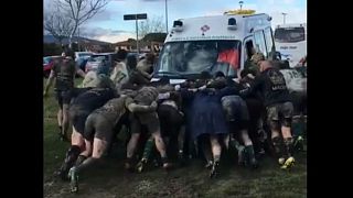 Rugby players form ‘scrum’ to free ambulance stuck in mud