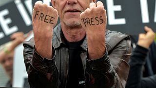 A man takes part in a protest organised by Amnesty International