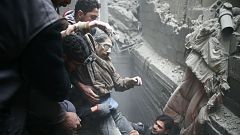 Civil defence help a man from a shelter in the besieged town of Douma