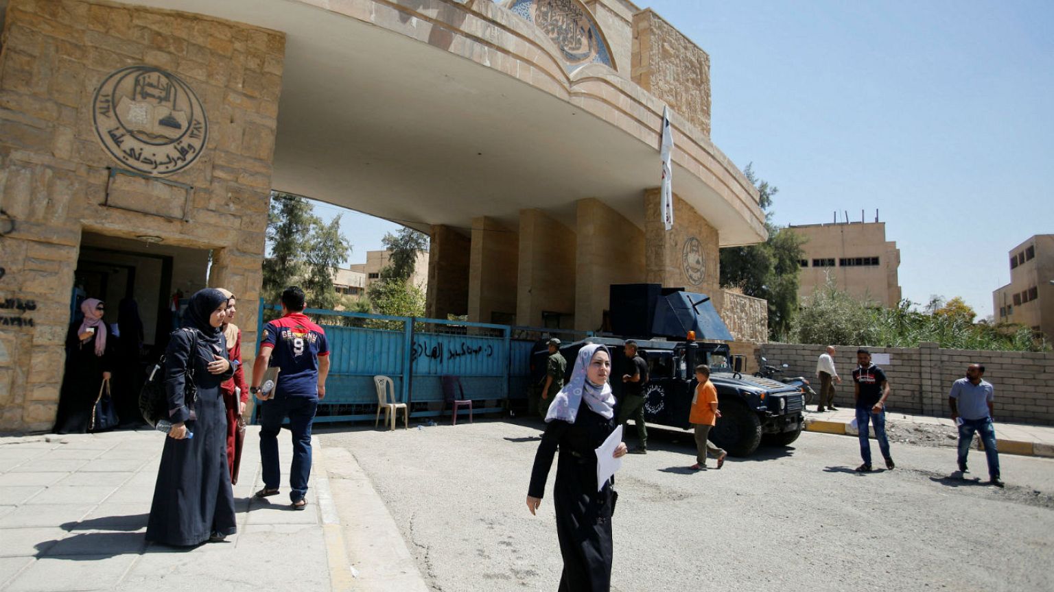 University of Mosul students walk outside the campus in Mosul