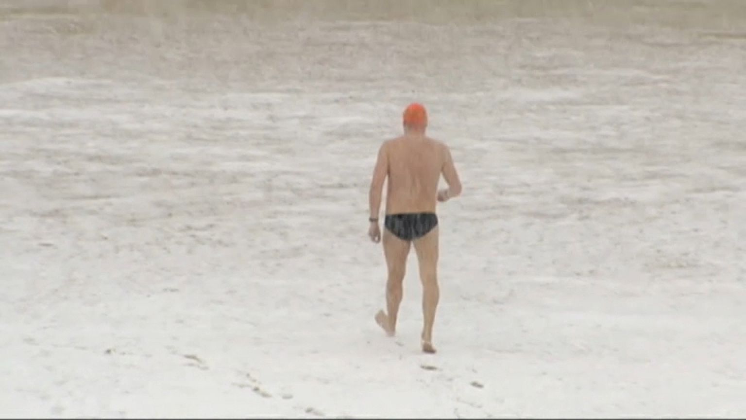 Brave swimmer in San Sebastian, Spain goes for a dip