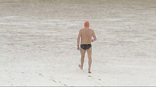 Brave swimmer in San Sebastian, Spain goes for a dip