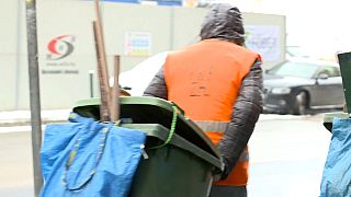 Homeless man walks down freezing street in Budapest