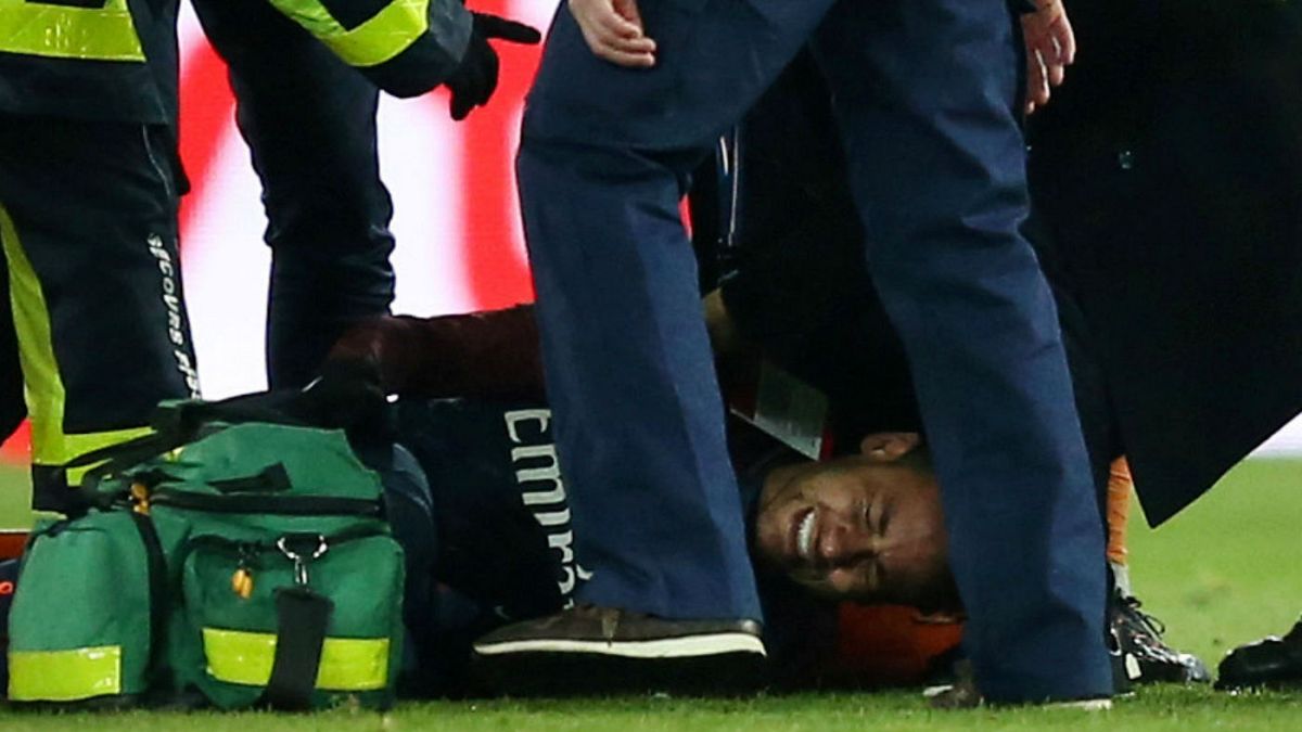 PSG Neymar receives treatment from medical staff after sustaining an injury