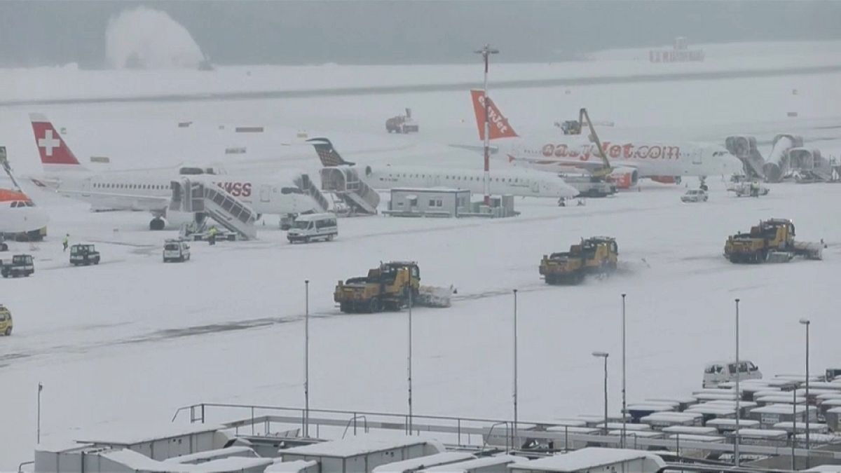 Snow ploughs clear snow from Geneva airport