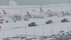 Snow ploughs clear snow from Geneva airport