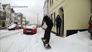 British Olympic bronze medallist Billy Morgan snowboards down street