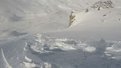 Snowboarder escapes getting buried by avalanche