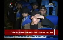 Report on Syrian TV shows small group boarding bus to leave