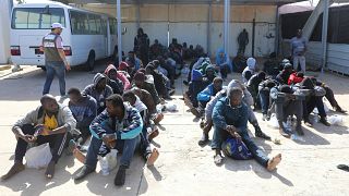 Migrants are seen at a naval base after being rescued by the Libyan coast 