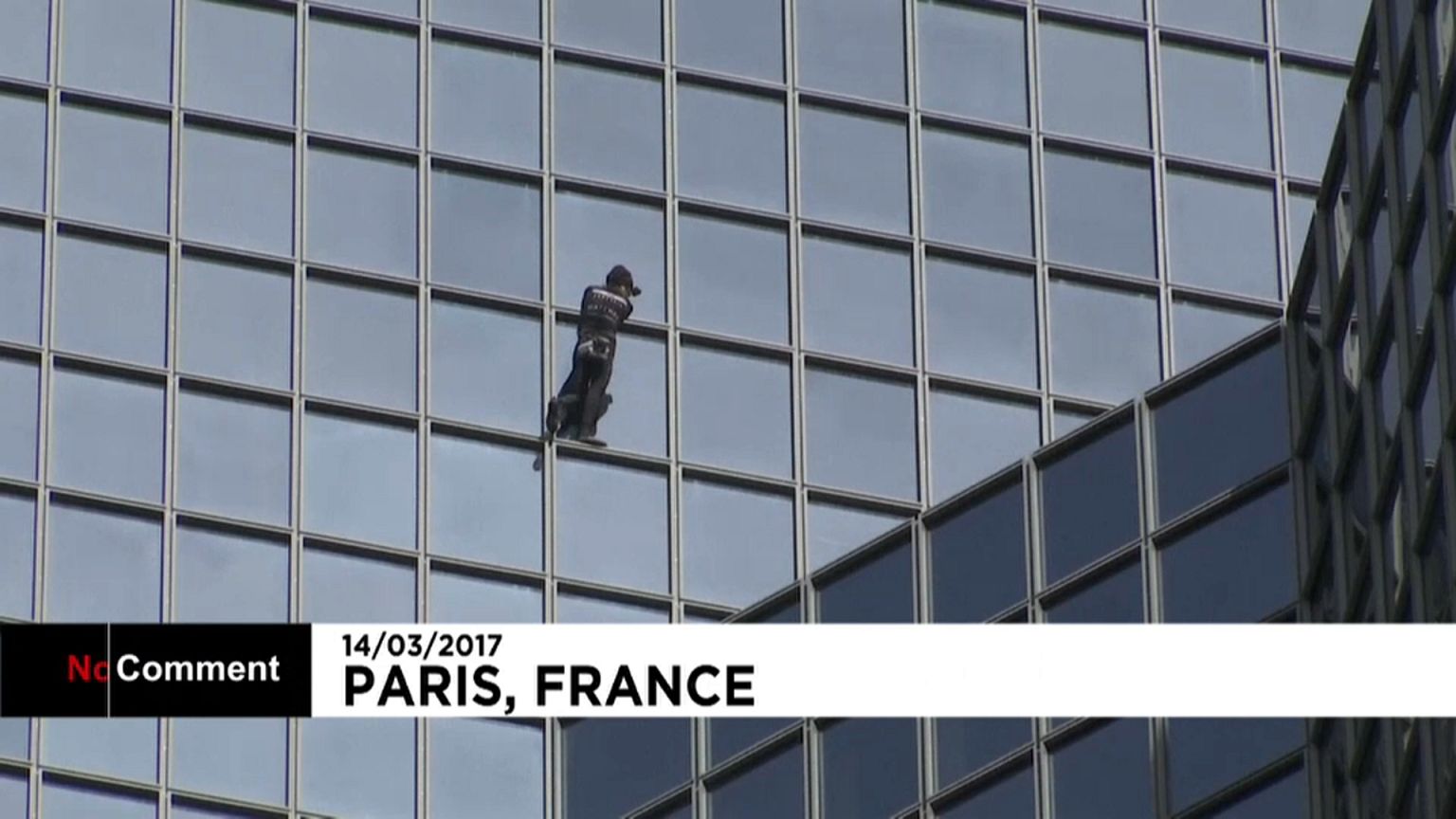 French climber Alain Robert scales skyscraper in Paris business district