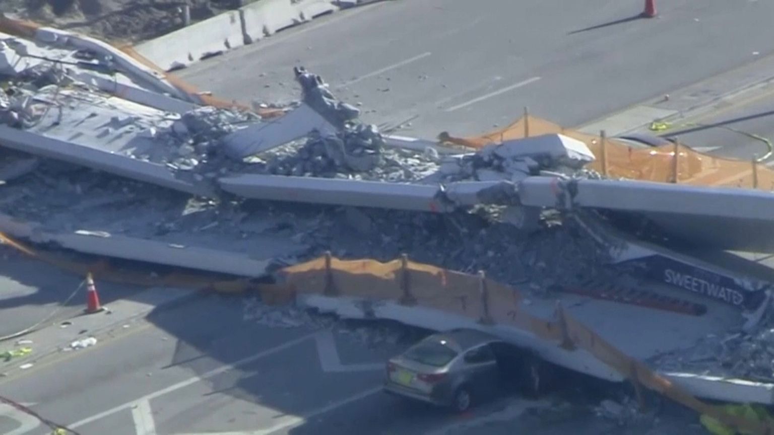 Several vehicles with bodies inside are still trapped under the rubble