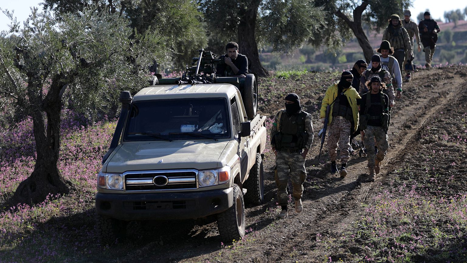 Turkish-backed Free Syrian Army fighters walk together after advancing 