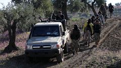 Turkish-backed Free Syrian Army fighters walk together after advancing 