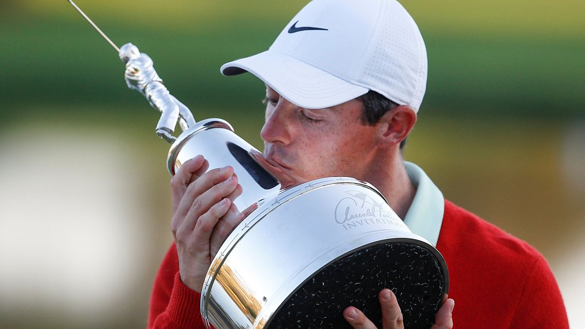Rory Mcllroy holds the Arnold Palmer trophy