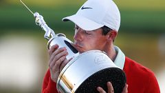 Rory Mcllroy holds the Arnold Palmer trophy