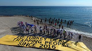 Amnesty activists with migrants stuck on Samos island last summer