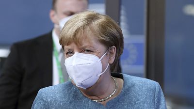 German Chancellor Angela Merkel, center, arrives for an EU summit at the European Council building in Brussels, Thursday, Oct. 1, 2020