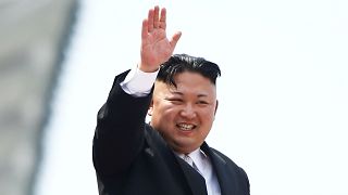 File photo: Kim Jong Un waves to crowds at a military parade in Pyongyang