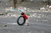 Boy leans on a tyre at a camp for internally displaced people near Sanaa