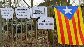 A Catalan separatist flag) is seen next to slogans in Neumuenster, Germany
